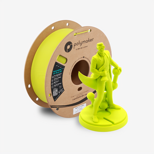 Additronix Polymaker HT-PLA-GF filament spool with green filament for 3D printing, shown with a power tool in the background.