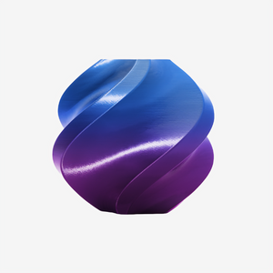 Additronix Bambu Lab PLA Silk filament in Aurora Purple with multi-color sheen, showing a spool of vibrant, glossy 3D printing filament.