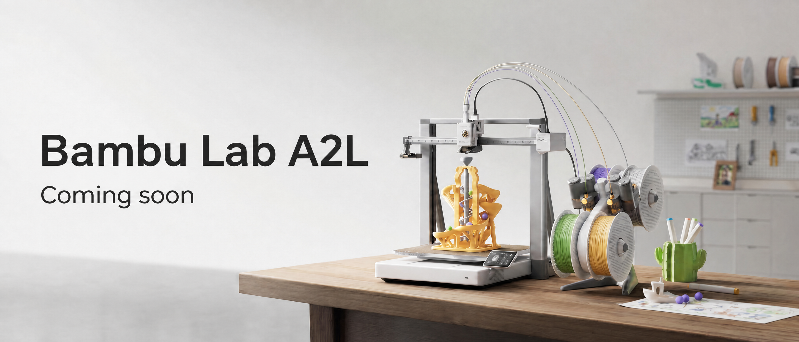 Bambu Lab A2L 3D printer on a wooden table.