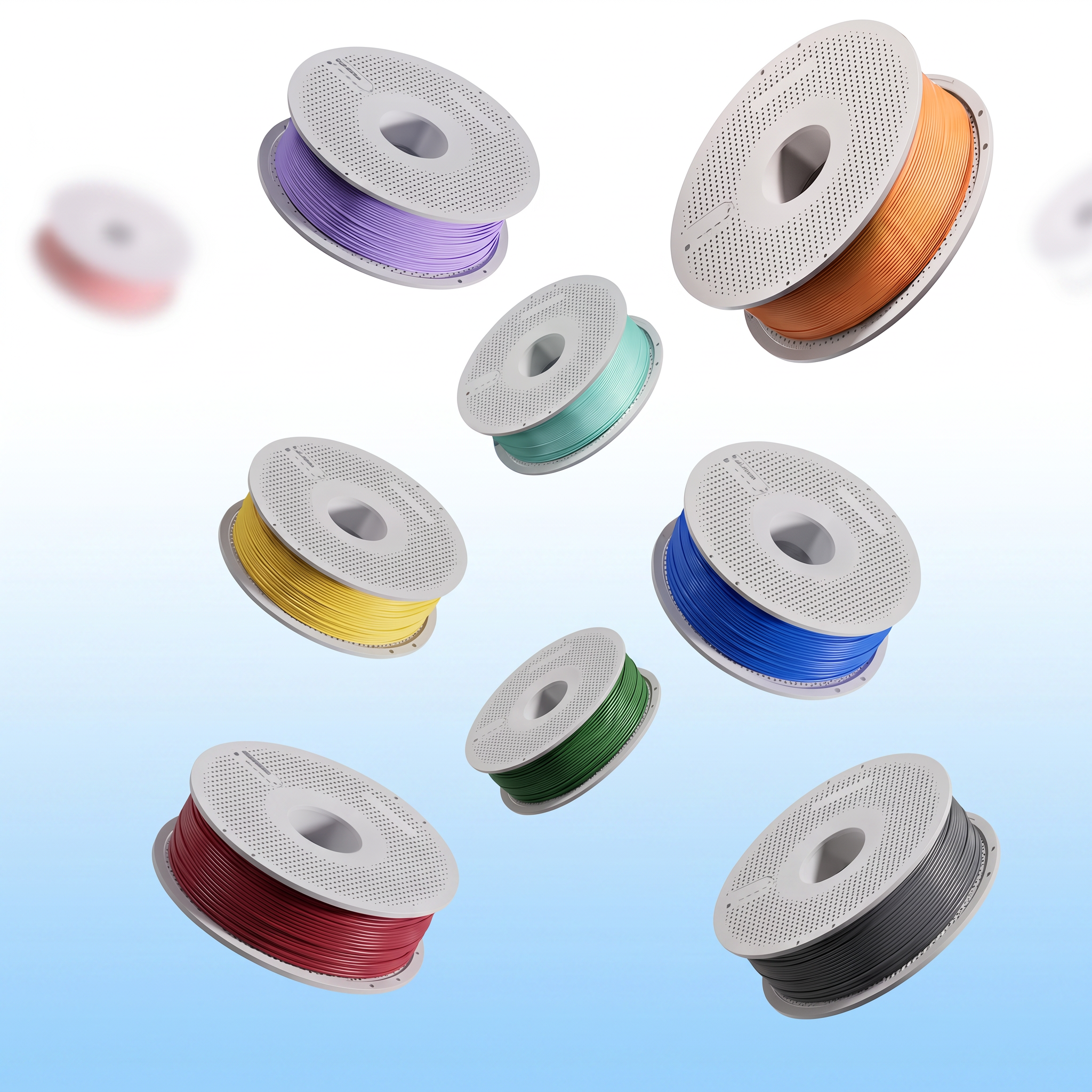 Set of colorful spools of filament on a light blue background